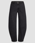 Mid-waisted barrel-leg jean in deep black denim, knee seams visible; front button and zipper closure, shown on light gray backdrop. Pleated hem detail at cuff adds volume.