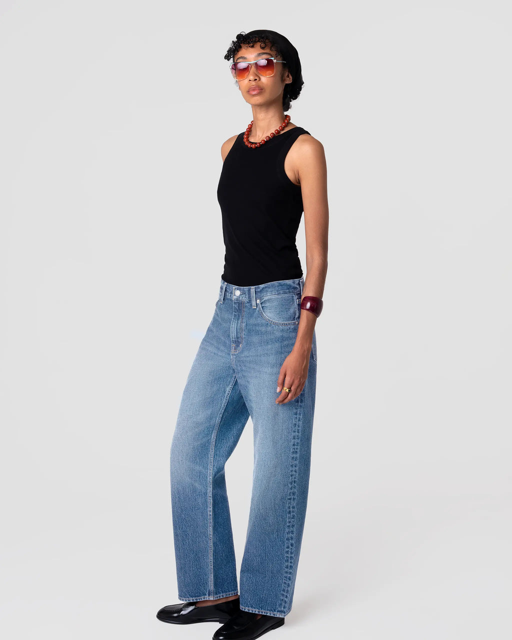 Oketo Cut 101 Straight Jean in Vintage Light; straight leg, mid-rise, vintage-faded indigo with a soft drape; worn with black tank.