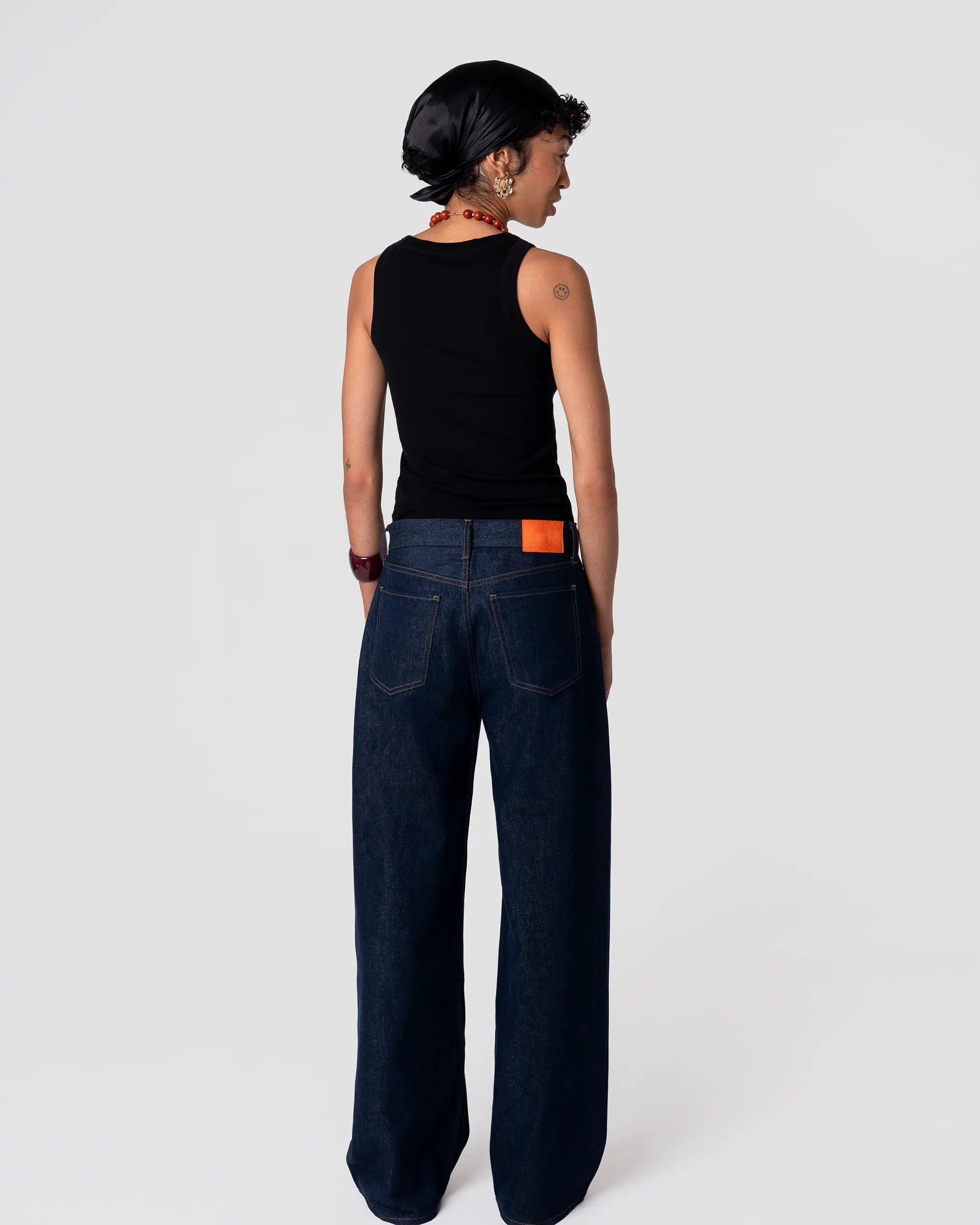 Rear view of Oketo Cut 102 wide-leg indigo rinse jeans in Japanese denim; structured fit, high rise, defined back pockets.