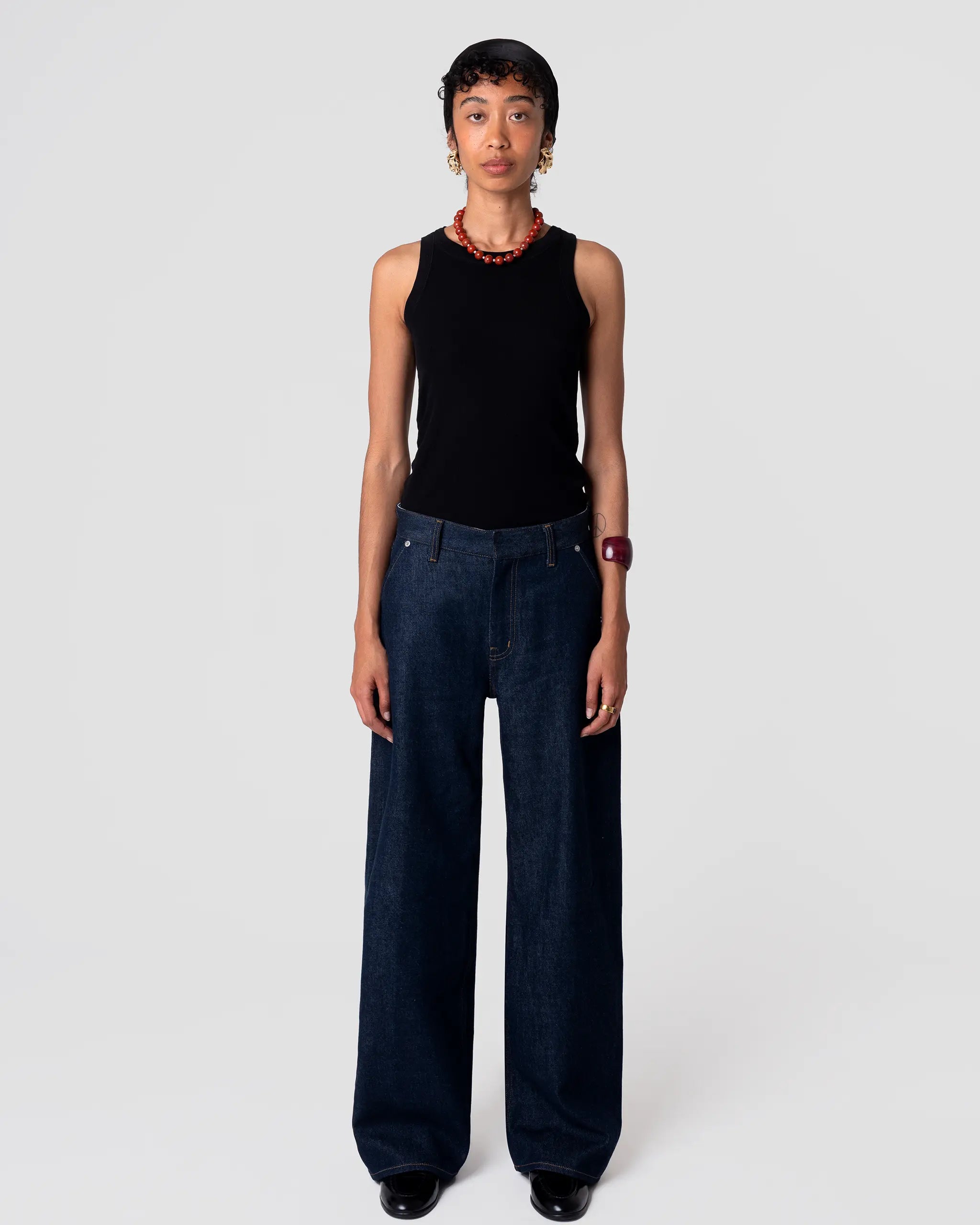 Straight-leg, mid-rise Oketo Cut 102 Tailored Jean in deep indigo rinse, clean finish; drapes from hip with structured silhouette.