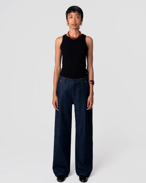 Straight-leg, mid-rise Oketo Cut 102 Tailored Jean in deep indigo rinse, clean finish; drapes from hip with structured silhouette.