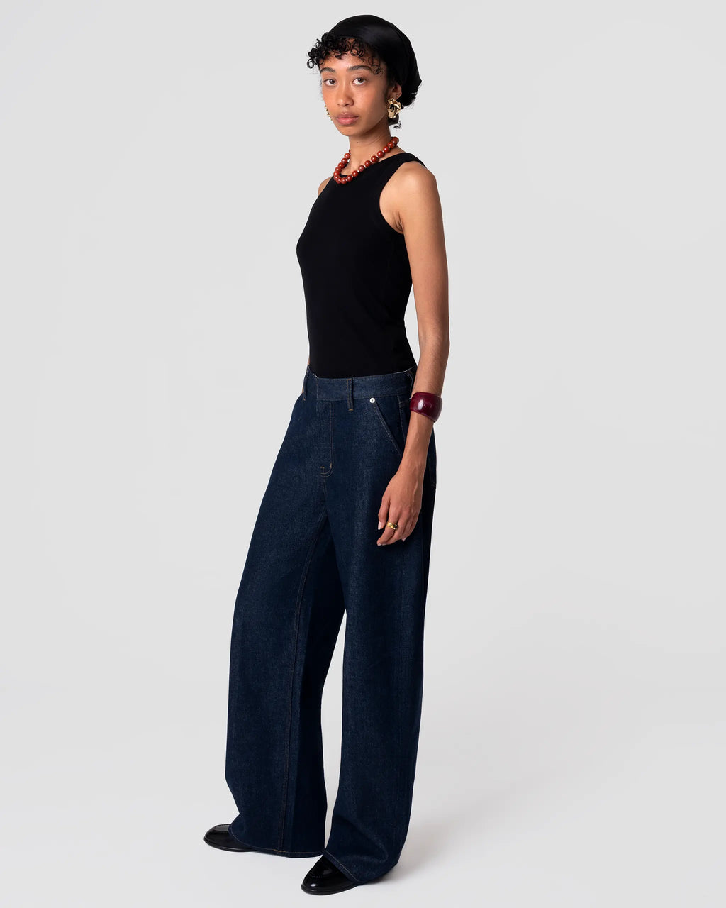 High-rise, tailored Oketo Cut 102 Jean in deep rinse indigo with clean finish; straight leg drapes from hip; shown on-body, front view.