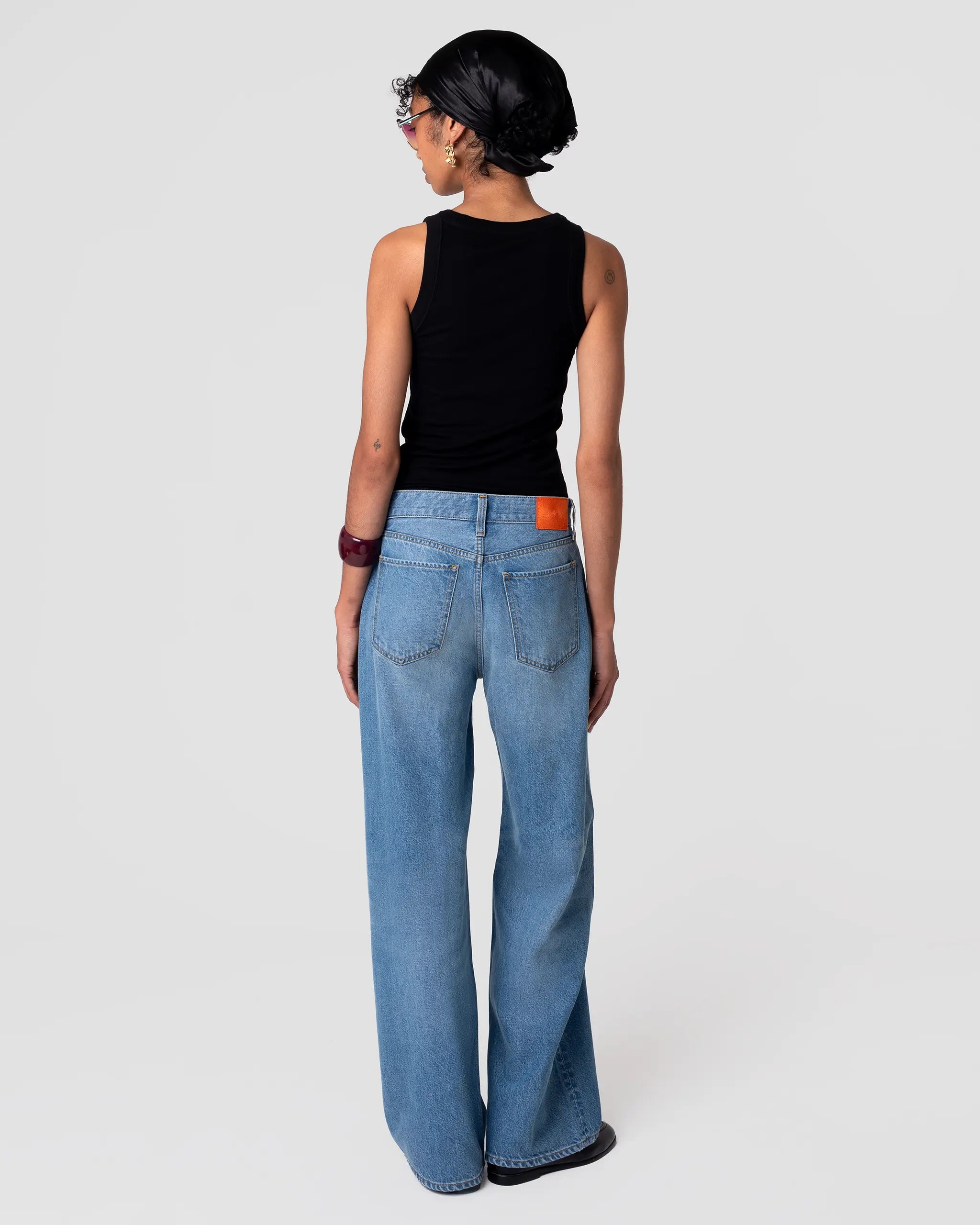Rear view of Cut 102 Tailored Jean in Vintage Light; straight leg, refined drape, pale indigo wash with gentle fading at seams.