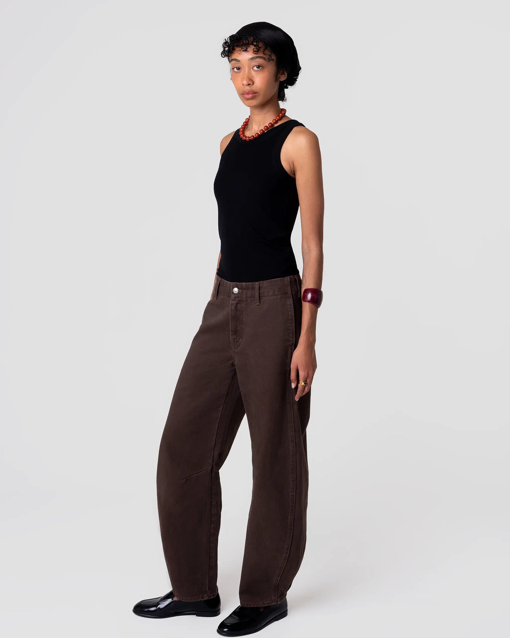 Cut 103 Barrel Jean in Espresso; structured barrel leg, subtle surface sheen, sits mid-rise with generous volume through leg and slight taper. Pleated hem detail at cuff adds volume.